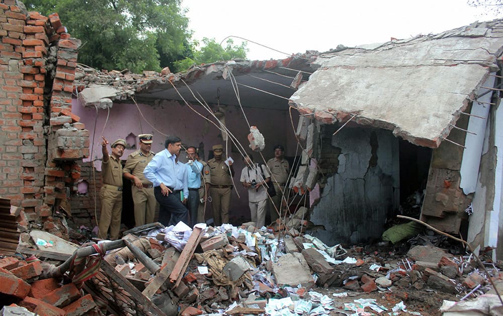 Police officials investigate the spot after an explosion in a crackers factory in Mohanlalganj area in Lucknow.