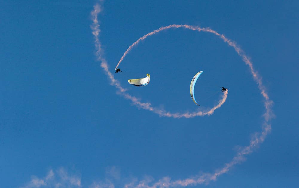 Paragliders perform acrobatic flights during the 41st Icare Cup paragliding festival in Saint Hilaire du Touvet, French Alps.