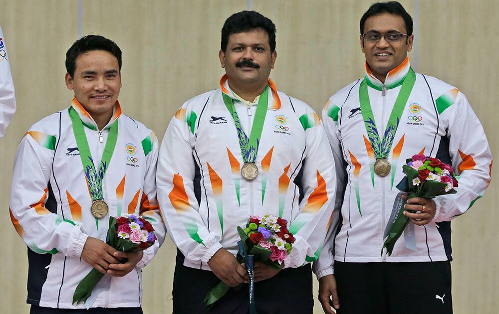 Bronze medalist, from left to right, Jitu Rai, Samaresh Jung and Prakas Papanna Nanjappa of India pose for photographers dduring the victory ceremony for the Men's 10m Air Pistol Team shooting competition at the 17th Asian Games at Ongnyeon International Shooting Range in Incheon, South Korea.