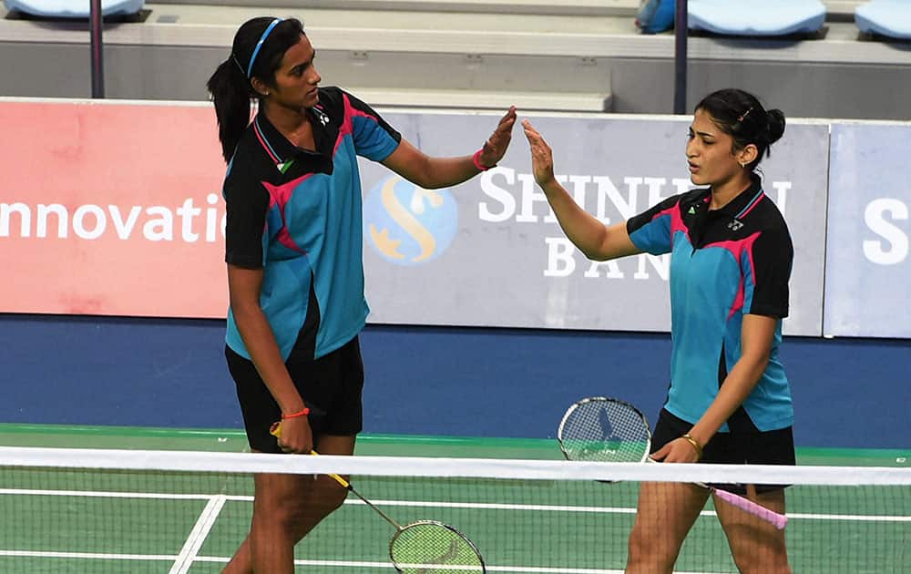 Indias P V Sindhu and Ashwini Chinnappa celebrate after winning a point against Thailand during the womens doubles team badminton Quarterfinal match at the Asian Games 2014.