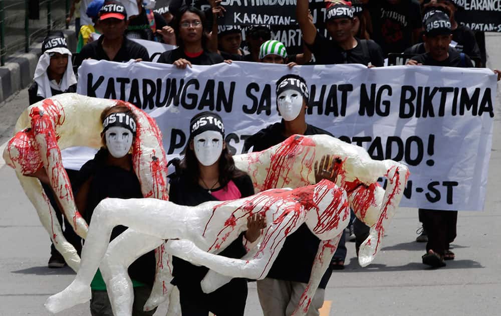 Protesters display effigies depicting human rights victims under Martial Law as they march towards the armed forces headquarters at suburban Quezon city, northeast of Manila, Philippines, to mark the 42nd anniversary of its imposition by the late strongman Ferdinand Marcos.