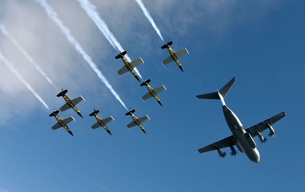 Seven L-39c Albatros aircraft from the Breitling Jet Team in the process of joining up for a formation flight with the latest offering from Airbus over Toulouse, France.