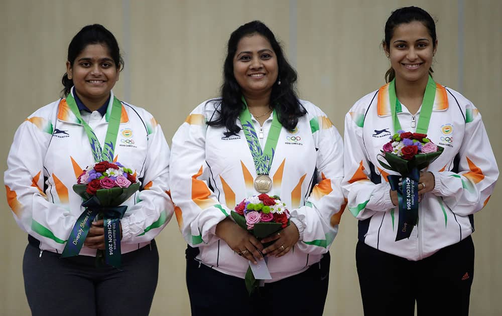 Bronze medalists of the women's 25m Rapid Fire Pistol Team shooting, from left, Rahi Jeevan Sarnobat, Anisa Sayyed and Heena Sidhu of India, pose for photographers during the victory ceremony at the 17th Asian Games at Ongnyeon International Shooting Range in Incheon, South Korea.