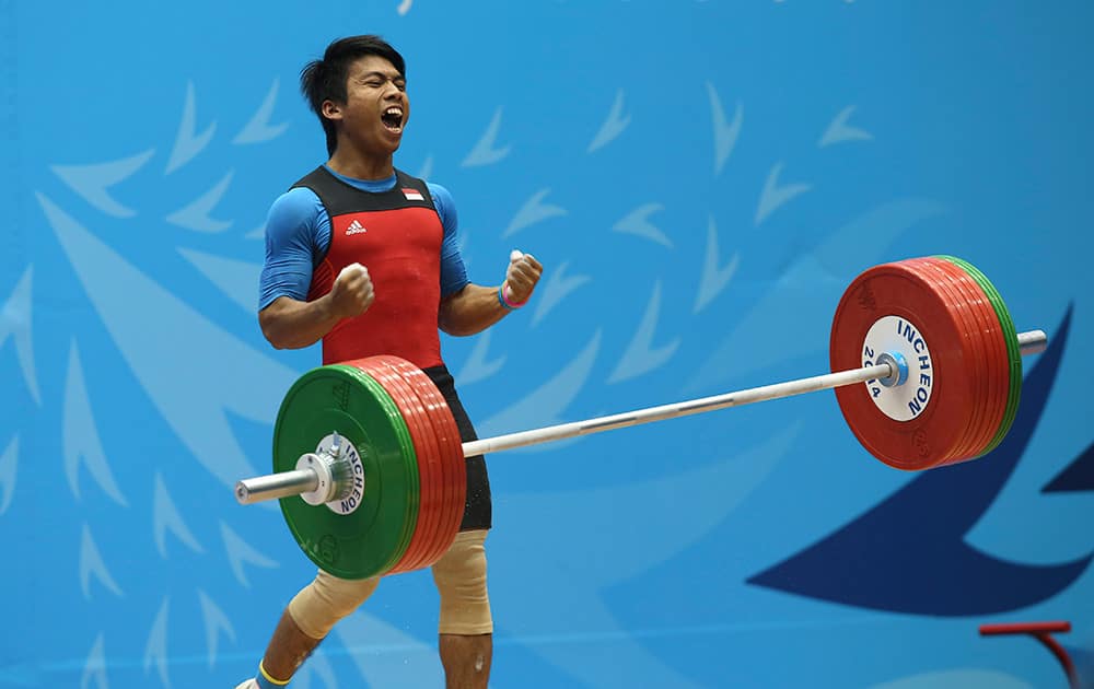 India's Deni reacts after a lift during the men's 69kg weightlifting competition at the 17th Asian Games in Incheon, Korea.