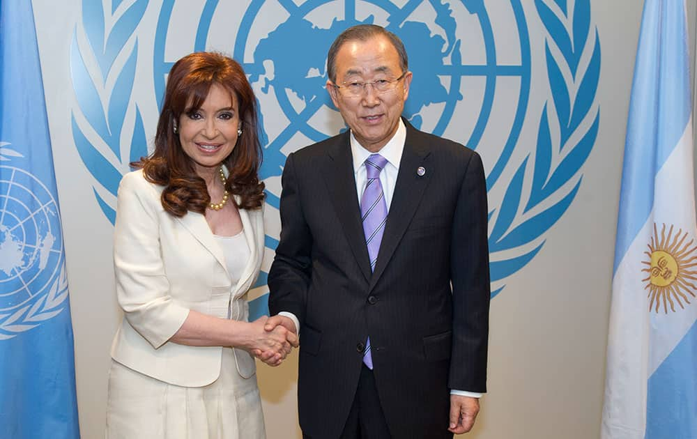 In this photo provided by the United Nations, Secretary-General Ban Ki-moon, right, poses for a handshake with Argentina's President Cristina Fernández, during the 69th session of the United Nations General Assembly at UN headquarters.