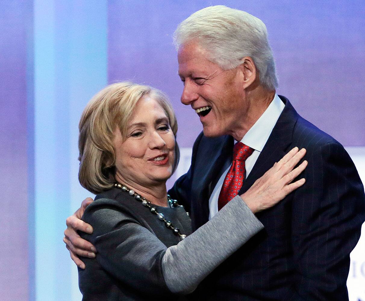 Former Secretary of State Hillary Rodham Clinton is welcomed to the stage by her husband, former US President Bill Clinton, at the Clinton Global Initiative in New York. 