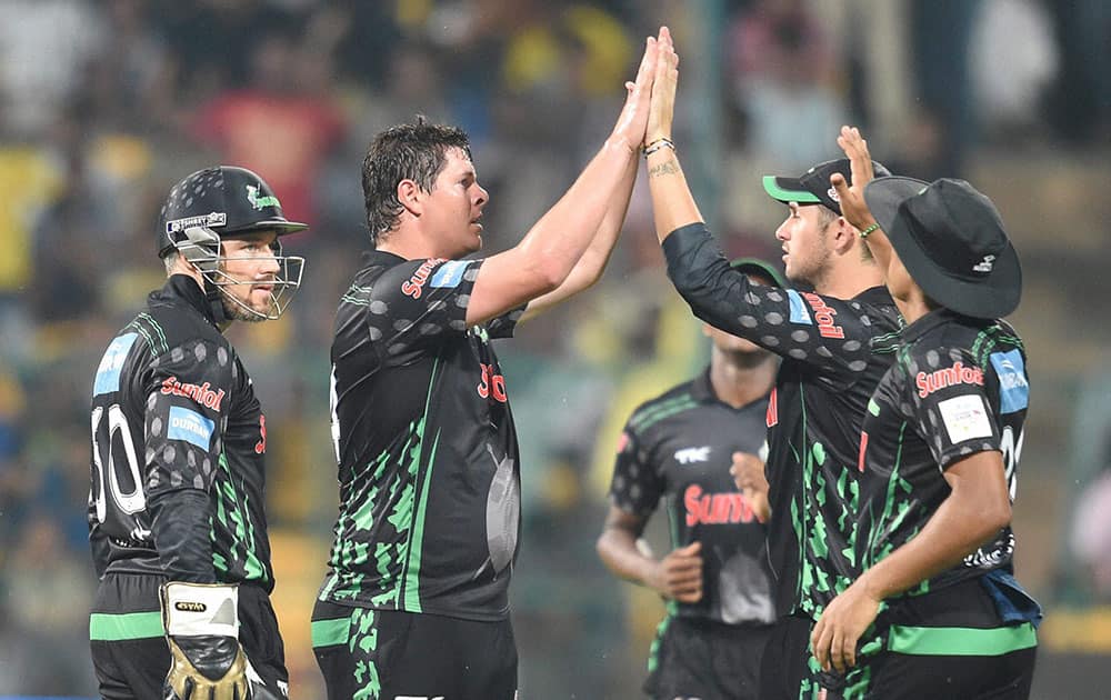 Dolphins bowler Robert Frylinck celebrates the wicket of Chennai Super Kings skipper MS Dhoni during the Champions League Twenty20 match at Chinnaswamy Stadium in Bengaluru.
