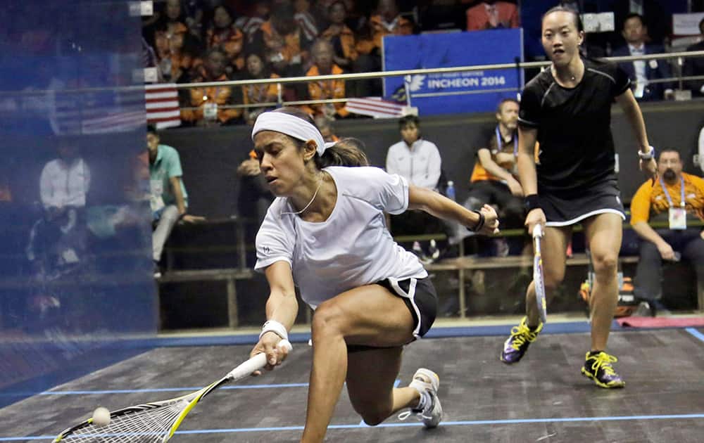 Malaysia's Nicol Ann David, left, returns the ball to her compatriot Lee Wee Wern during their women's singles squash final match at the 17th Asian Games in Incheon, South Korea.