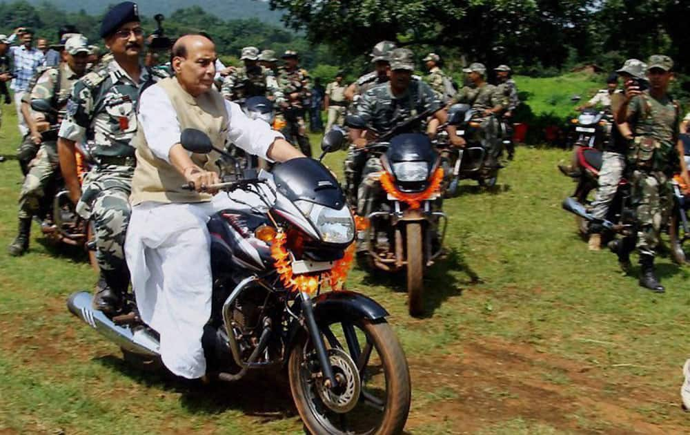 Union Home Minister Rajnath Singh drives a motorcycle at Thalkobad CRPF camp in Saranda forest of Chaibasa in Jharkhand.