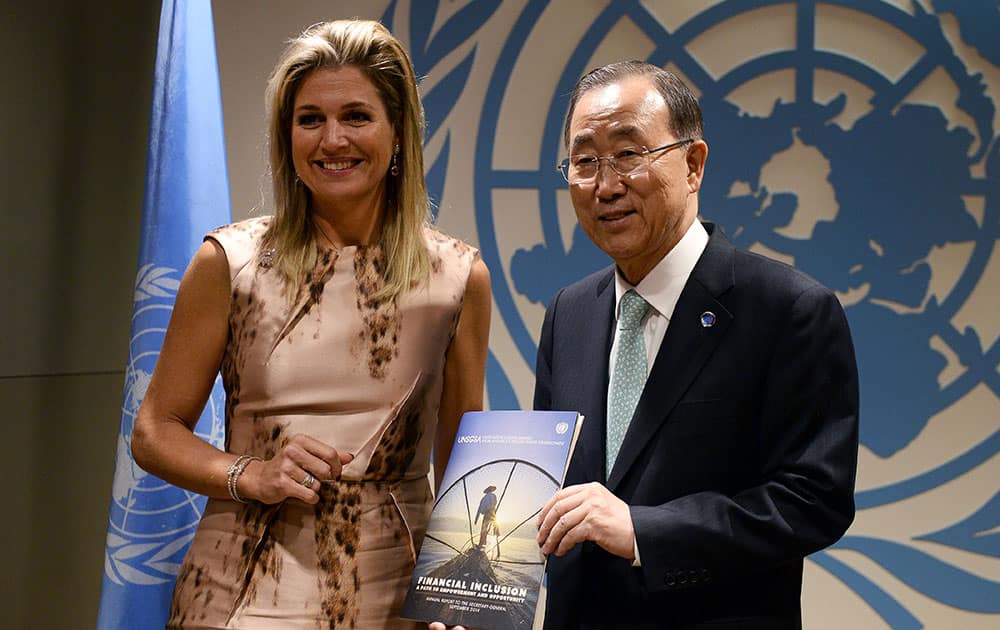 Queen Maxima of the Netherlands hands an annual report on financial inclusion to UN Secretary-General Ban Ki-moon before a meeting at the United Nations on the sideline of the 69th Session of the UN General Assembly. 