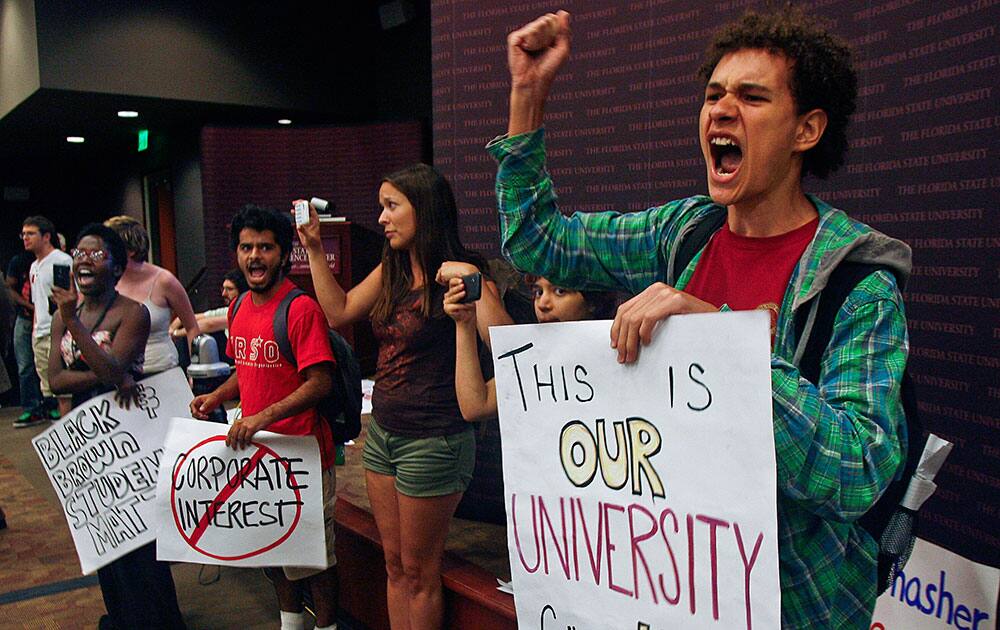 Moments after a vote is taken to choose a new president, students yell and interrupt a meeting of the Florida State University Board of Trustees.