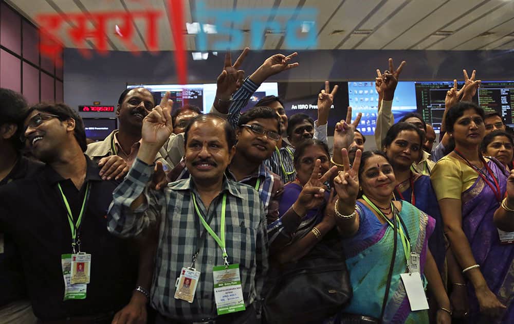 Indian Space Research Organization scientists and other officials cheer as they celebrate the success of Mars Orbiter Mission at their Telemetry, Tracking and Command Network complex in Bangalore.