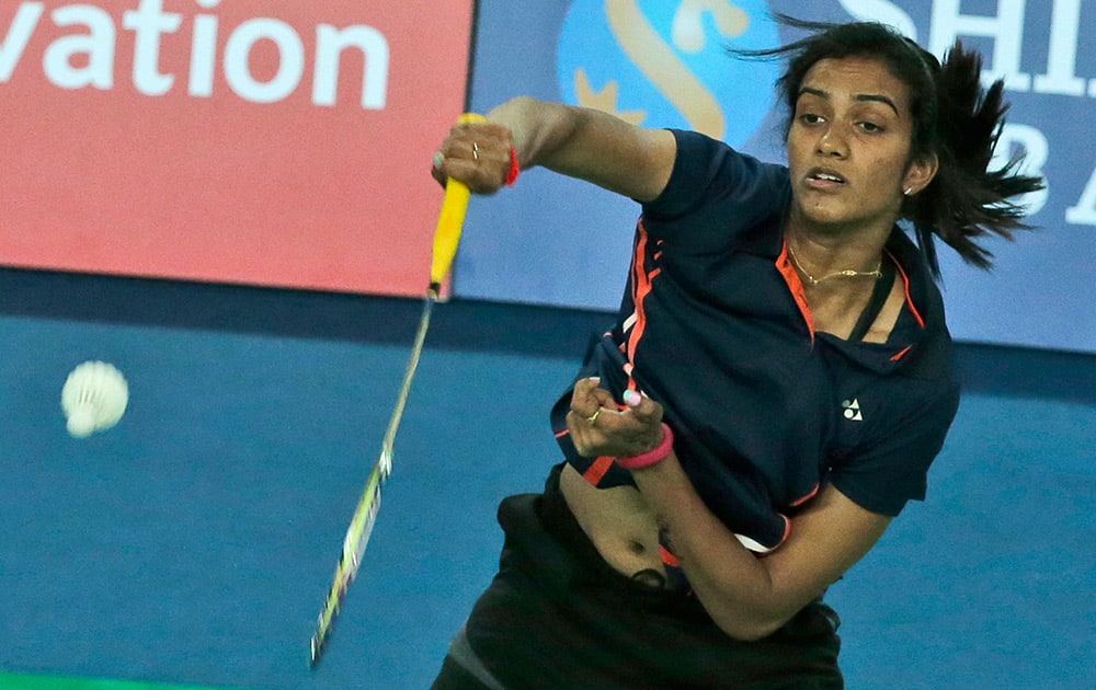 India's P.V. Sindhu returns the shuttlecock against Wong Kit Leng of Macau during their Women's Singles badminton match at the 17th Asian Games in Incheon, South Korea.