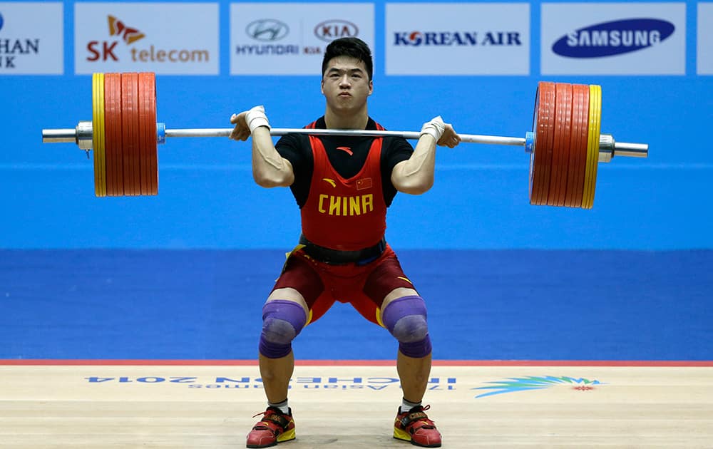Tian Tao of China attempts a lift during the men's 85-kg, group A, weightlifting competition at the 17th Asian Games in Incheon.