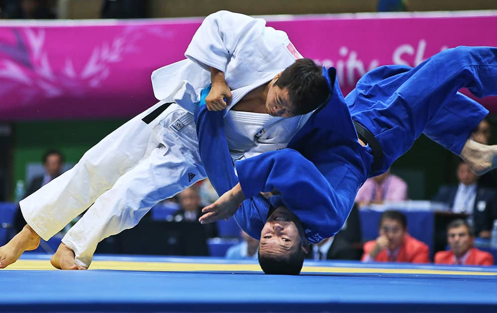 South Korea's Lee Kyu-won, in white, competes against Kazakhstan's Timur Bolat during the men's Judo team contest for gold medal at the 17th Asian Games Tuesday, Sept. 23, 2014 in Incheon.