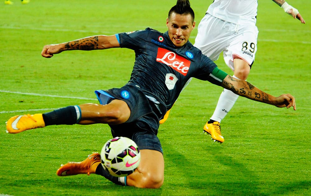 Napoli's Marek Hamsik, left, chased by Palermo's Sinisa Andelkovic, tries to control the ball during a Serie A soccer match between Napoli and Palermo at the San Paolo stadium in Naples, Italy.