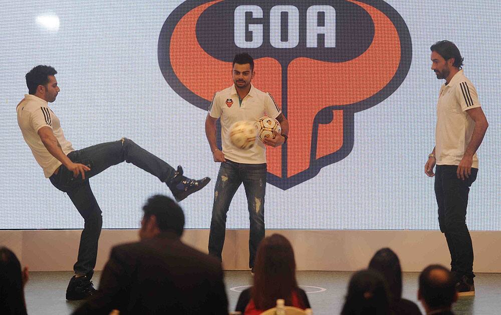 Varun Dhawan (L), Virat Kohli (C) and Robert Pires (R) during the press confrence in Mumbai. dna