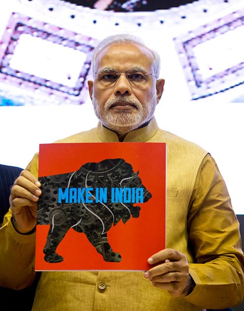 Prime Minister Narendra Modi, unveils the logo of 'Make in India' initiative in New Delhi.