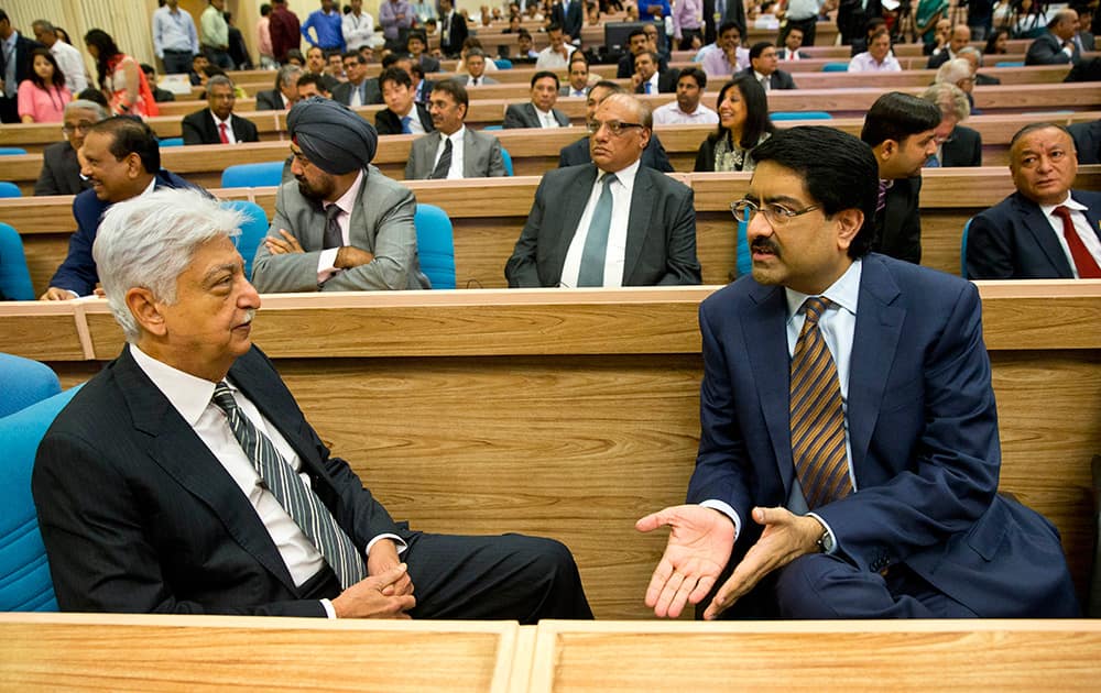 Wipro Chairman Azim Premji, left talks to Aditya Birla Group Chairman Kumar Mangalam Birla as they attend the launch of 'Make in India' initiative in New Delhi.