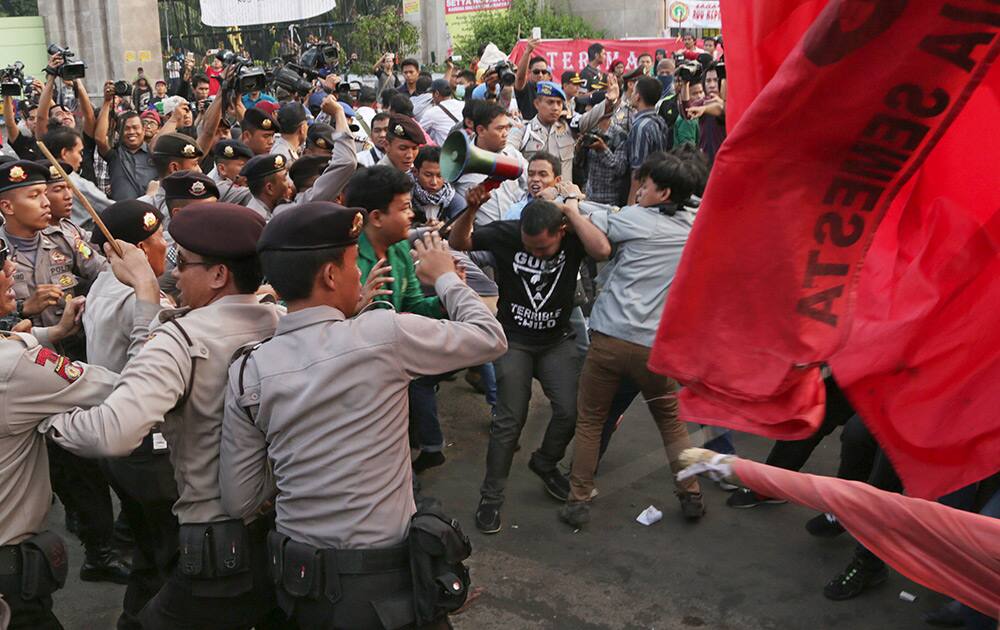 Indonesian police block protesters during a rally, opposing a regional election bill in front of the parliament building in Jakarta, Indonesia.