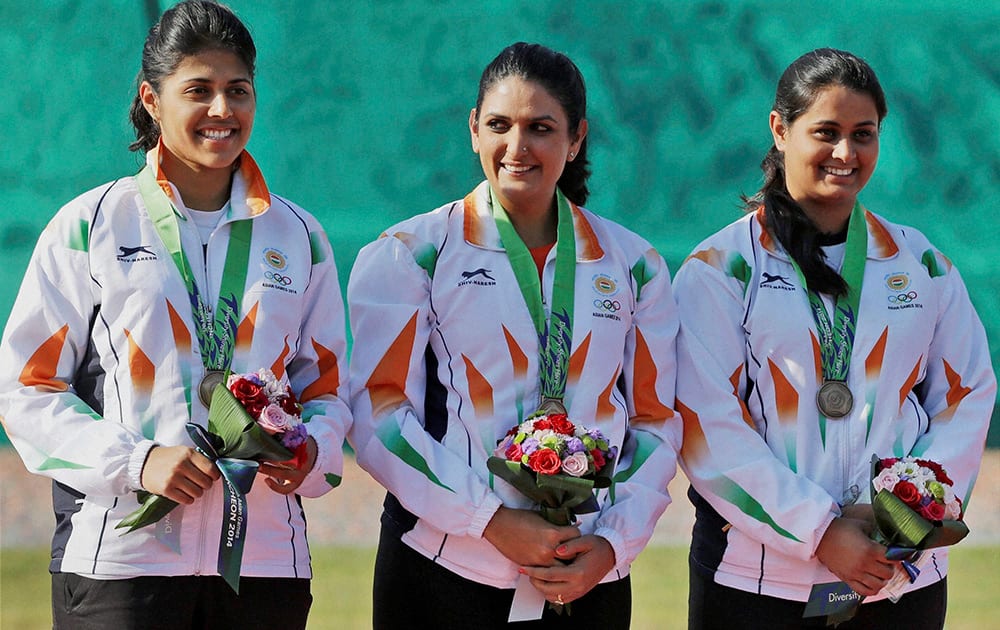 Bronze medalist from left to right, Varman Varsha, Shagun Chowdary and Shreyasi Singh pose for photographers during the medal ceremony for the Womens Double Trap Team shooting competition at the 17th Asian Games in Incheon, South Korea.