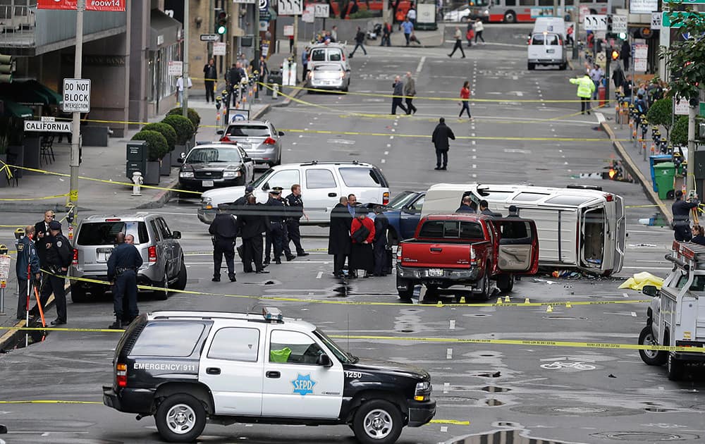 San Francisco police officers investigate the scene where a high-speed car chase ended with a crash and the fatal shooting of a carjacking suspect, in San Francisco.