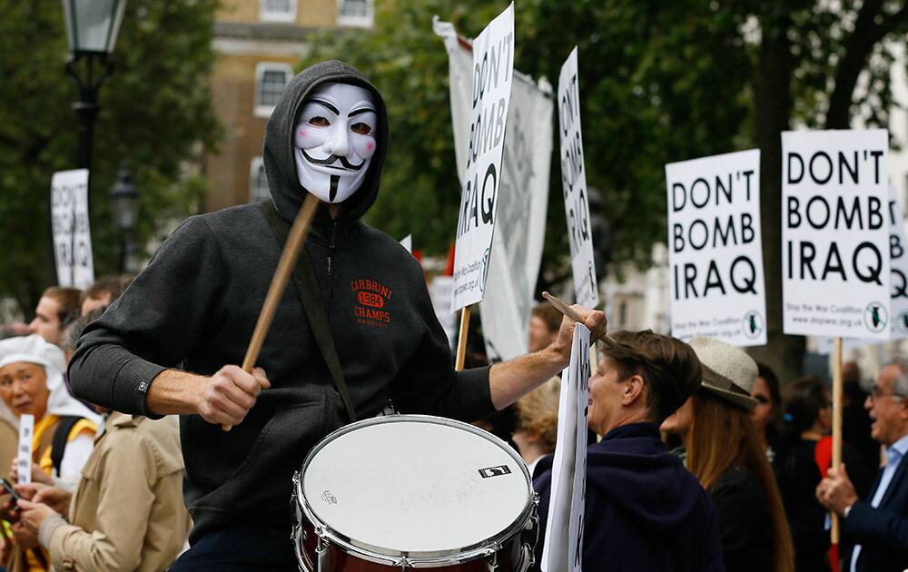 A demonstrator bangs a drum at an anti-war demonstration near Downing Street in London.