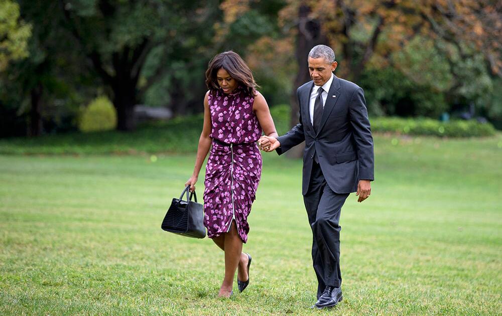 President Barack Obama and first lady Michelle Obama walk on the South Lawn of the White House in Washington.