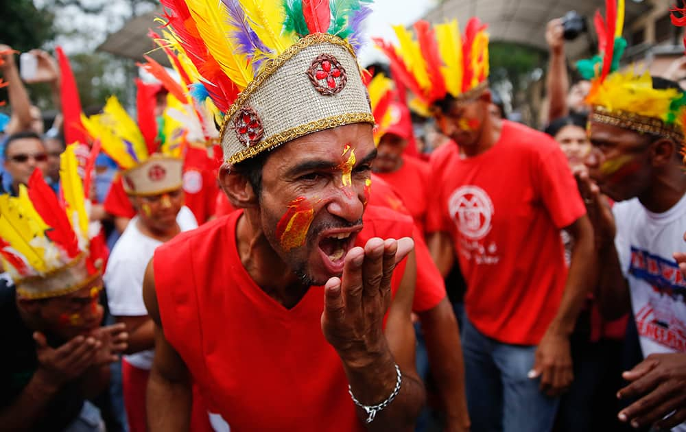 A member of the homeless movement dressed as indian play acts a rain dance during a protest against the lack of water and housing in Sao Paulo, Brazil.