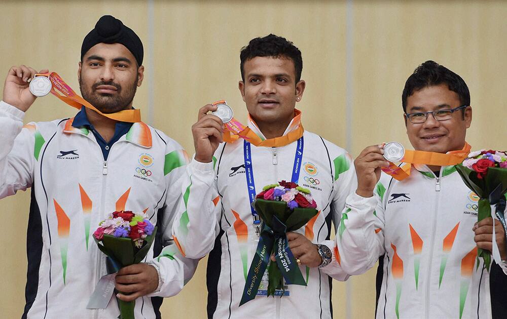 Silver medalist Vijay Kumar , Tamang Pemba,Gurpreet Singh in mens 25m Center pistol event during a victory ceremony at the Ongnyeon International Shooting Range at the 17th Asian Games in Incheon, South Korea.