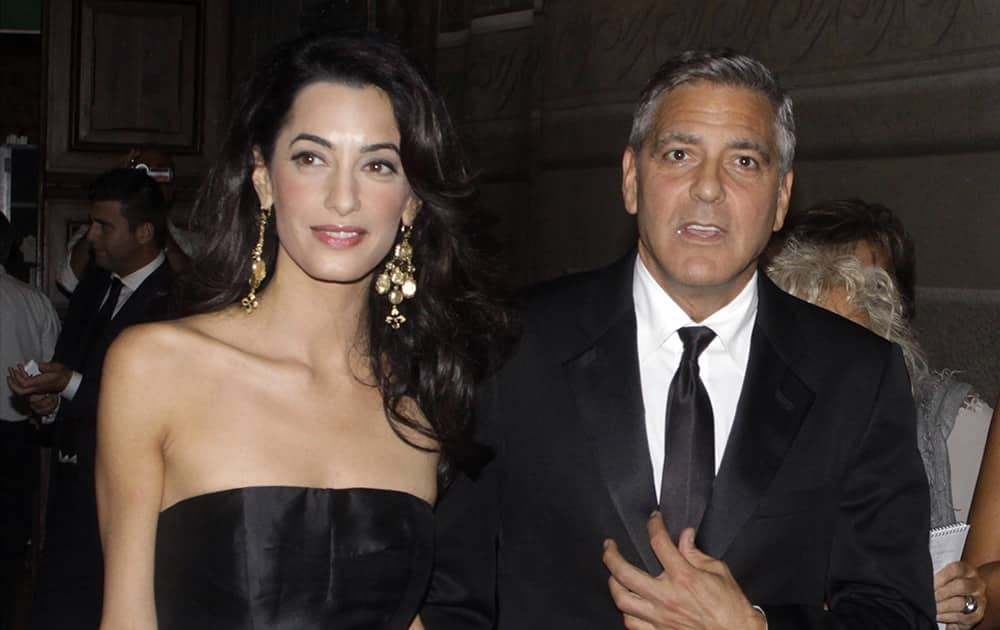 File Photo: eorge Clooney and his fiancee Amal Alamuddin arrive for the 'Celebrity Fight Night' foundation gala dinner, in Florence, Italy.