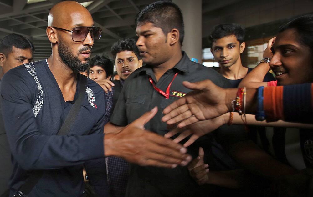 French soccer player Nicolas Anelka, shakes hand with his fans on his arrival at the Mumbai international airport.