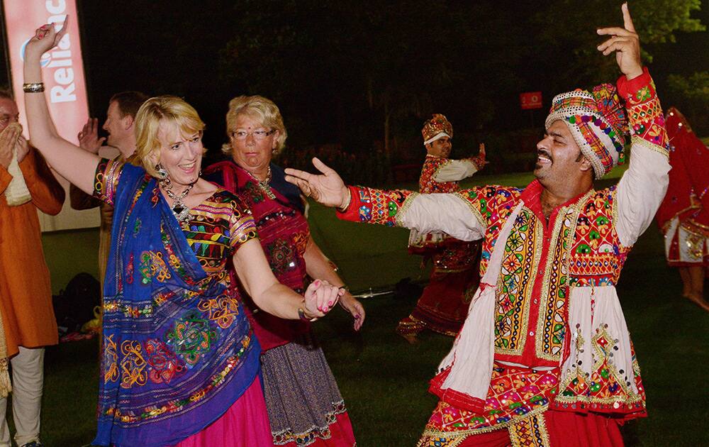 A foreign girl, wearing a traditional dress, performs Garba on the first day of Navratri celebrations in Ahmedabad.