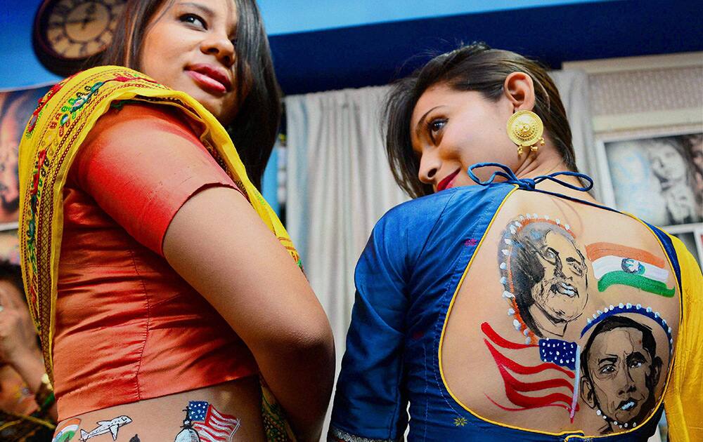 Girls showing their bodies painted with pictures of US President Obama, Prime Minister Narendra Modi, to mark PM Modis visit to the US, in Ahmedabad.