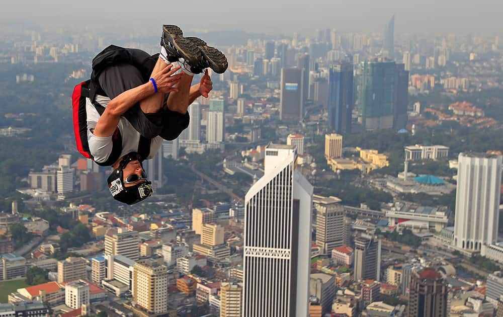 BASE jumper Patrick Grivillers of France dives in the air from the Kuala Lumpur Tower during the KL Tower International Jump in Kuala Lumpur, Malaysia