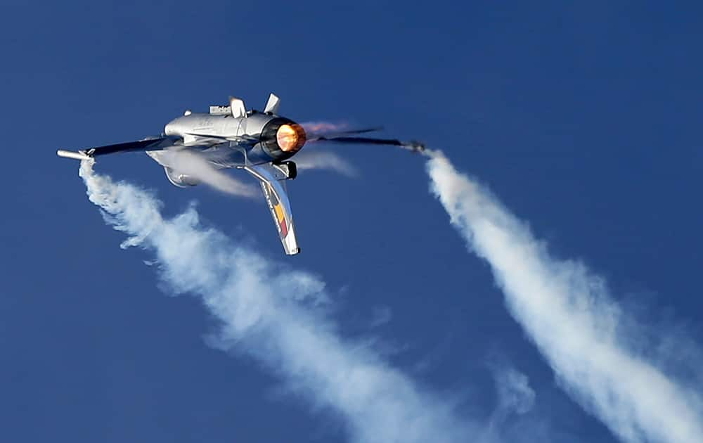 A Belgian F16 fighter jet is inverted as it takes part in an aerobatic display in northern Athens