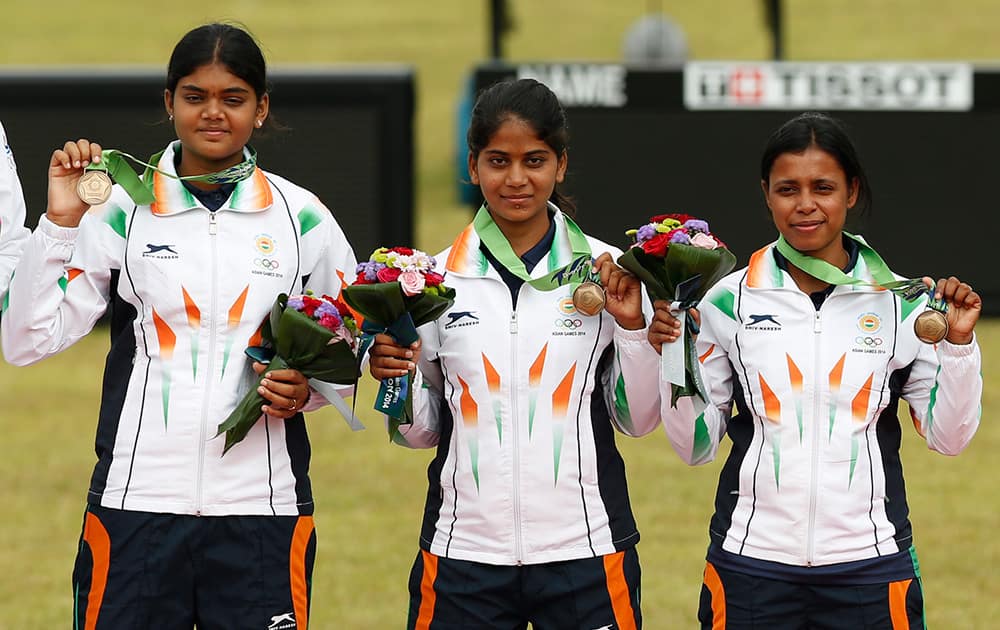 Bronze medal winners India's team members Jyothi Surekha Vennam, Purvasha Sudhir Shende, Trisha Deb celebrate after winning the compound women's team gold medal archery match at the 17th Asian Games in Incheon.