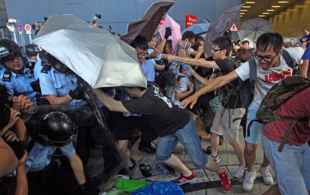 Riot policemen scuffle with protesters after young pro-democracy activists forced their way into Hong Kong government headquarters during a demonstration in Hong Kong