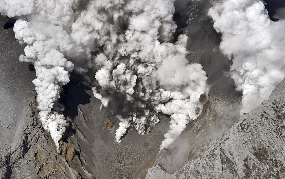 Dense fumes are spewed out from several spots on the slope of Mt. Ontake as the volcano erupts in central Japan.