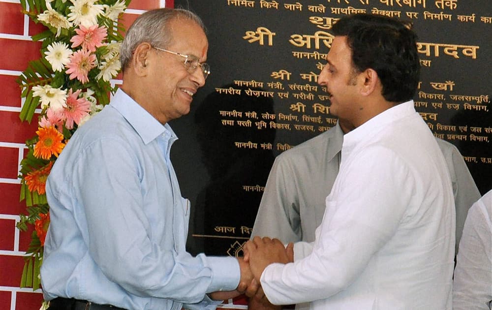 Uttar Pradesh Chief Minister Akhilesh Yadav shakes hands with Metro man E Sreedharan during the foundation stone-laying of the Lucknow Metro Rail Project (LMRP) in Lucknow.