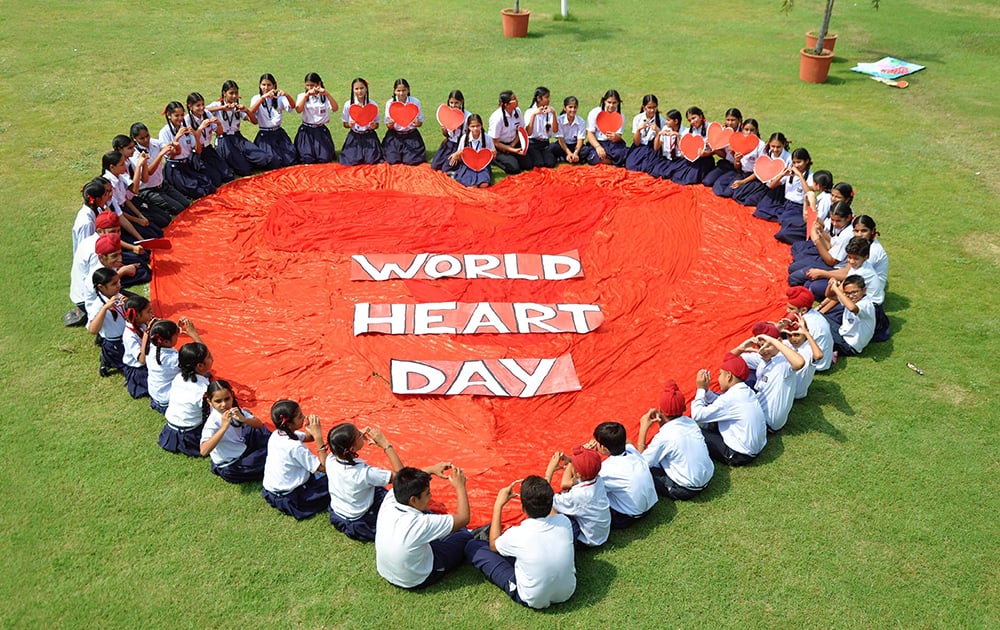 School Students making a a formation in the shape of a heart on the occasion of World Heart Day at a school near Patiala.