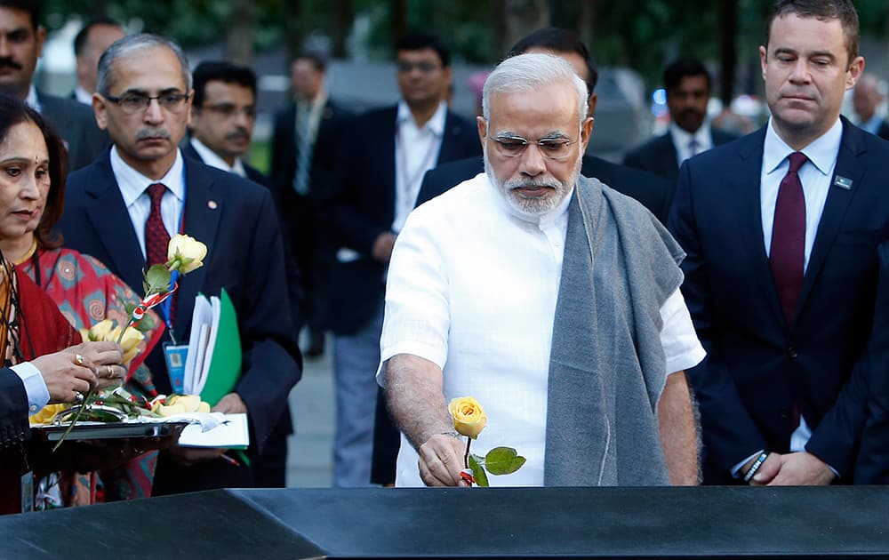 Prime Minister Narendra Modi of India lays roses on the names of Indian victims of the Sept. 11 attacks during a visit to the National September 11 Memorial, in New York.