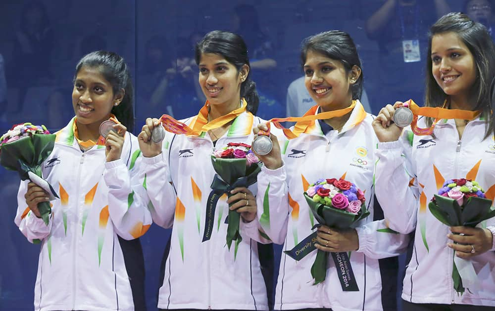 India’s Anaka Alankamony, left, Joshna Chinapp, 2nd left, Aparajitha Balamurukan, 2nd right, and Deepika Pallikal, right, pose with their silver medals during the women's team squash award ceremony at the 17th Asian Games.