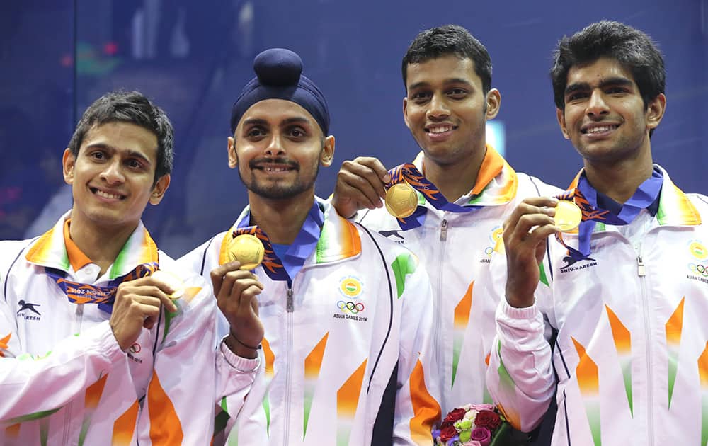 India's Saurav Ghosal, left, Harinder Pal Singh Sandhu, 2nd left, Mahesh Mangaonkar, 2nd right, and Kumar Kush, right, pose with their gold medals during the men's team squash award ceremony at the 17th Asian Games.