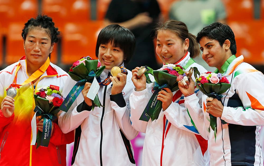 Silver medallist China’s Xiluo Zhuoma, gold medallist Japan’s Rio Watari, bronze medallists Mongolia’s Tserenchimed Sukhee and India’s Geetika Jakhar pose with their medals for the women’s freestyle 63kg gold bout at the 17th Asian Games in Incheon.