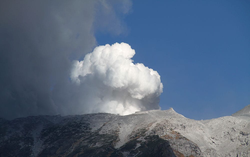 Plumes of smoke and ash billow from Mount Ontake as it continues to erupt in Otaki village, in Nagano prefecture, Japan.