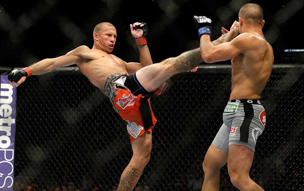 Donald Cerrone kicks Eddie Alvarez in their lightweight mixed martial arts bout at UFC 178 in Las Vegas. 