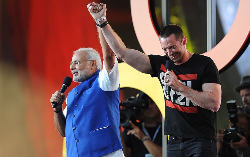 Prime Minister of India Narendra Modi, left and Hugh Jackman speak at the 3rd Global Citizen Festival at Central Park in New York. 