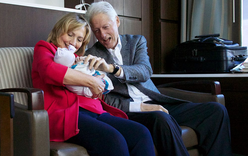 former Secretary of State Hillary Rodham Clinton, left, and former President Bill Clinton, right with their granddaughter Charlotte Clinton Mezvinsky at Lenox Hill Hospital in New York. 