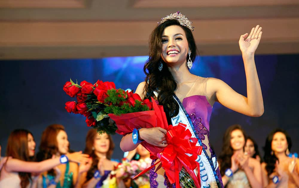 Wyne Lay, winner of the Miss Myanmar World 2014 pageant poses for photos after she was crowned  in Yangon, Myanmar. 